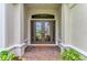 Elegant double front doors with decorative glass, framed by stately columns and a brick walkway at 15315 Derna Ter, Bradenton, FL 34211