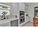 Close up of kitchen with white cabinets, marble countertops, stainless appliances, and a window over the sink at 15315 Derna Ter, Bradenton, FL 34211