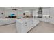 Bright kitchen with an oversized island, stainless appliances, and open floor plan to the dining and living areas at 15315 Derna Ter, Bradenton, FL 34211