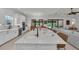 Spacious kitchen with a large island, sink, and access to the living room with comfortable seating at 15315 Derna Ter, Bradenton, FL 34211