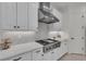 Modern kitchen with stainless steel appliances, custom cabinetry, and a sleek gas range at 15315 Derna Ter, Bradenton, FL 34211