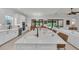 Open concept kitchen with a view of the living room and pool, featuring an island with bar seating at 15315 Derna Ter, Bradenton, FL 34211