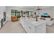 Bright kitchen features a large island with white cabinets and modern finishes at 15315 Derna Ter, Bradenton, FL 34211