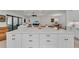 Large island features white cabinets and a stunning countertop, great for entertaining at 15315 Derna Ter, Bradenton, FL 34211