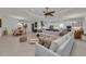 Open-concept living room with a dining area, bright kitchen, and large sectional sofa at 15315 Derna Ter, Bradenton, FL 34211