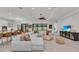Living area with sectional sofa and view to kitchen, featuring light-colored tiling at 15315 Derna Ter, Bradenton, FL 34211