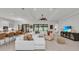 Open-concept living area with modern furniture, tile flooring, and views into the kitchen at 15315 Derna Ter, Bradenton, FL 34211