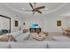 Comfortable living room with modern decor, a ceiling fan, and a large screen television at 15315 Derna Ter, Bradenton, FL 34211