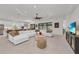 Open-concept living area with modern furniture, tile flooring, and views into the kitchen at 15315 Derna Ter, Bradenton, FL 34211