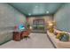 This room has patterned wallpaper, a wooden desk and chair, and a white sofa with decorative pillows at 15315 Derna Ter, Bradenton, FL 34211