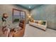 This office area is decorated with patterned wallpaper and features a white couch and brown leather chair at 15315 Derna Ter, Bradenton, FL 34211