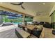 Spacious patio features a dining area, a fire pit, and views of the pool and backyard at 15315 Derna Ter, Bradenton, FL 34211