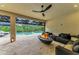 Spacious patio features a fire pit, comfortable seating, and views of the pool and backyard at 15315 Derna Ter, Bradenton, FL 34211