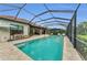 Screened pool and lanai with covered dining and sun lounger area, set off a home with a terracotta roof at 15315 Derna Ter, Bradenton, FL 34211