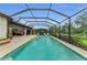 Covered lanai with dining area adjacent to screened pool with integrated hot tub and sun loungers at 15315 Derna Ter, Bradenton, FL 34211