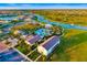 Community aerial view highlighting clubhouse, pool and spa, lake with fountain and surrounding neighborhood homes at 17128 Ranchside Pl, Lakewood Ranch, FL 34211