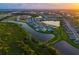 An aerial view shows the community featuring numerous houses, serene lakes, and lush green spaces at 17128 Ranchside Pl, Lakewood Ranch, FL 34211