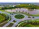 Beautiful aerial view of a roundabout with a star and a scenic pond with fountains in a well-maintained community at 17128 Ranchside Pl, Lakewood Ranch, FL 34211