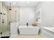 Modern bathroom with a luxurious soaking tub, walk-in shower, and stylish fixtures at 17128 Ranchside Pl, Lakewood Ranch, FL 34211