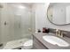 Beautiful bathroom featuring a glass enclosed shower and modern vanity with a round mirror at 17128 Ranchside Pl, Lakewood Ranch, FL 34211