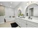 Elegant bathroom featuring double sinks, a soaking tub, a glass enclosed shower and modern finishes at 17128 Ranchside Pl, Lakewood Ranch, FL 34211