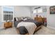 Bedroom with natural light and neutral colors, including a wooden bed frame and sport themed decor at 17128 Ranchside Pl, Lakewood Ranch, FL 34211