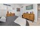 Nicely decorated bedroom with two wood dressers, shutters, and sport themed wall decor at 17128 Ranchside Pl, Lakewood Ranch, FL 34211