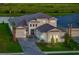 Beautiful home with a three-car garage, a well-manicured lawn, and a paver driveway at 17128 Ranchside Pl, Lakewood Ranch, FL 34211