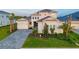 Beautiful home with a three-car garage, well-manicured lawn, and lush landscaping at 17128 Ranchside Pl, Lakewood Ranch, FL 34211