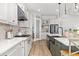 Bright kitchen featuring white cabinets, a large center island, modern appliances, and stylish lighting at 17128 Ranchside Pl, Lakewood Ranch, FL 34211