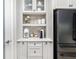 Kitchen with custom cabinets, modern appliances, and built-in shelving offering convenience at 17128 Ranchside Pl, Lakewood Ranch, FL 34211