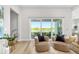 Light-filled living room with stylish seating, sliding glass doors, and views of the lake and patio at 17128 Ranchside Pl, Lakewood Ranch, FL 34211