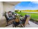 Cozy patio space overlooking a scenic view of a grassy backyard and a serene pond at 17128 Ranchside Pl, Lakewood Ranch, FL 34211