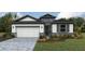 Charming single-Gathering home featuring a two-car garage, stone accents, and professionally landscaped front yard at 1749 Cobb Trl, Parrish, FL 34219