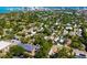 Aerial view of a neighborhood with houses nestled among trees and proximity to the bay and city skyline at 1871 Prospect St, Sarasota, FL 34239