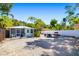 Spacious backyard featuring a light green house, screened-in porch, grill, and white privacy fence at 1871 Prospect St, Sarasota, FL 34239