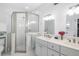 Well-lit bathroom with a glass-enclosed shower, double sink vanity, and classic white finishes at 1871 Prospect St, Sarasota, FL 34239