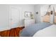 Bright bedroom features hardwood floors, white dresser, and a sunlit window with sheer curtains at 1871 Prospect St, Sarasota, FL 34239