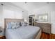 Bright bedroom with wood floors, walk-in closet, and a comfortable bed with plenty of natural light at 1871 Prospect St, Sarasota, FL 34239