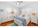 Comfortable bedroom with natural light, wood floors, and a cozy bed with stylish accents at 1871 Prospect St, Sarasota, FL 34239