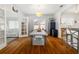 Bright dining room with wood floors, modern table with seating for six, and adjacent to a living room at 1871 Prospect St, Sarasota, FL 34239