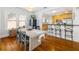 Bright dining area with a modern table, seamlessly connected to an open kitchen and bar at 1871 Prospect St, Sarasota, FL 34239