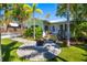 Charming cottage with inviting backyard, fire pit, and lush lawn, perfect for outdoor enjoyment at 1871 Prospect St, Sarasota, FL 34239