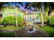 Charming, light green single-story house with a cozy fire pit in the front patio at 1871 Prospect St, Sarasota, FL 34239