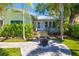 Charming home with a well-maintained front yard, featuring a fire pit, lush greenery, and a cozy porch at 1871 Prospect St, Sarasota, FL 34239