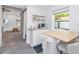 Modern kitchenette with sink, butcher block countertop, and minimalist shelves at 1871 Prospect St, Sarasota, FL 34239