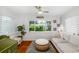 Bright living room with a large window overlooking lush landscaping and features comfortable seating at 1871 Prospect St, Sarasota, FL 34239