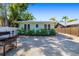 View of the rear exterior with gravel and fence, featuring a grill, plants and pleasant landscaping at 1871 Prospect St, Sarasota, FL 34239
