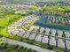 An aerial view displays the home nestled in a neighborhood with community lakes and mature landscaping throughout at 2070 Crystal Lake Trl, Bradenton, FL 34211