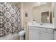 Clean bathroom features a tub with a shower, decorative shower curtain, and vanity at 2070 Crystal Lake Trl, Bradenton, FL 34211